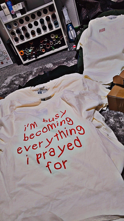 I'm busy becoming everything I prayed for Unisex Oversized Tee