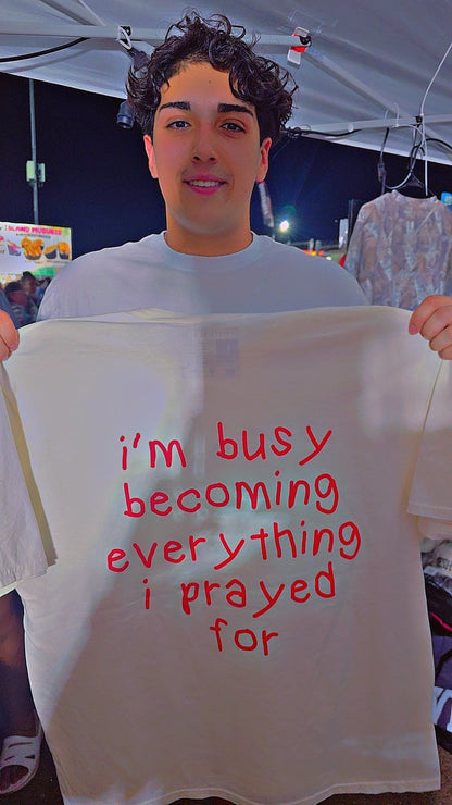 I'm busy becoming everything I prayed for Unisex Oversized Tee