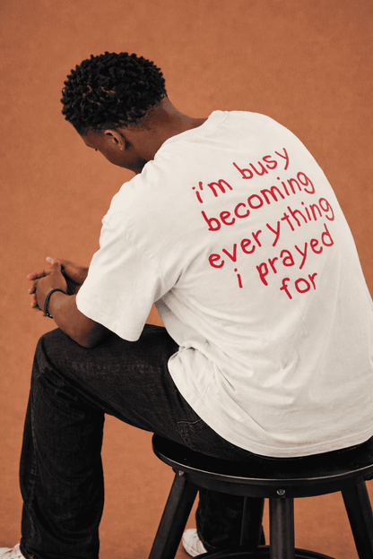 I'm busy becoming everything I prayed for Unisex Oversized Tee